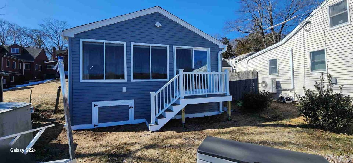 Blue siding home with new white stairs | Connecticut home renovations | Sunwood