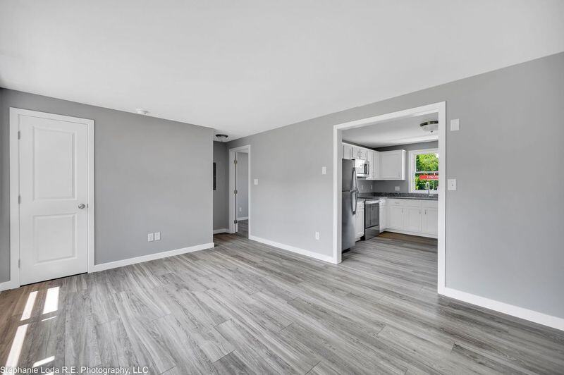 Living room view into bright white kitchen | rental property in Connecticut | Sunwood