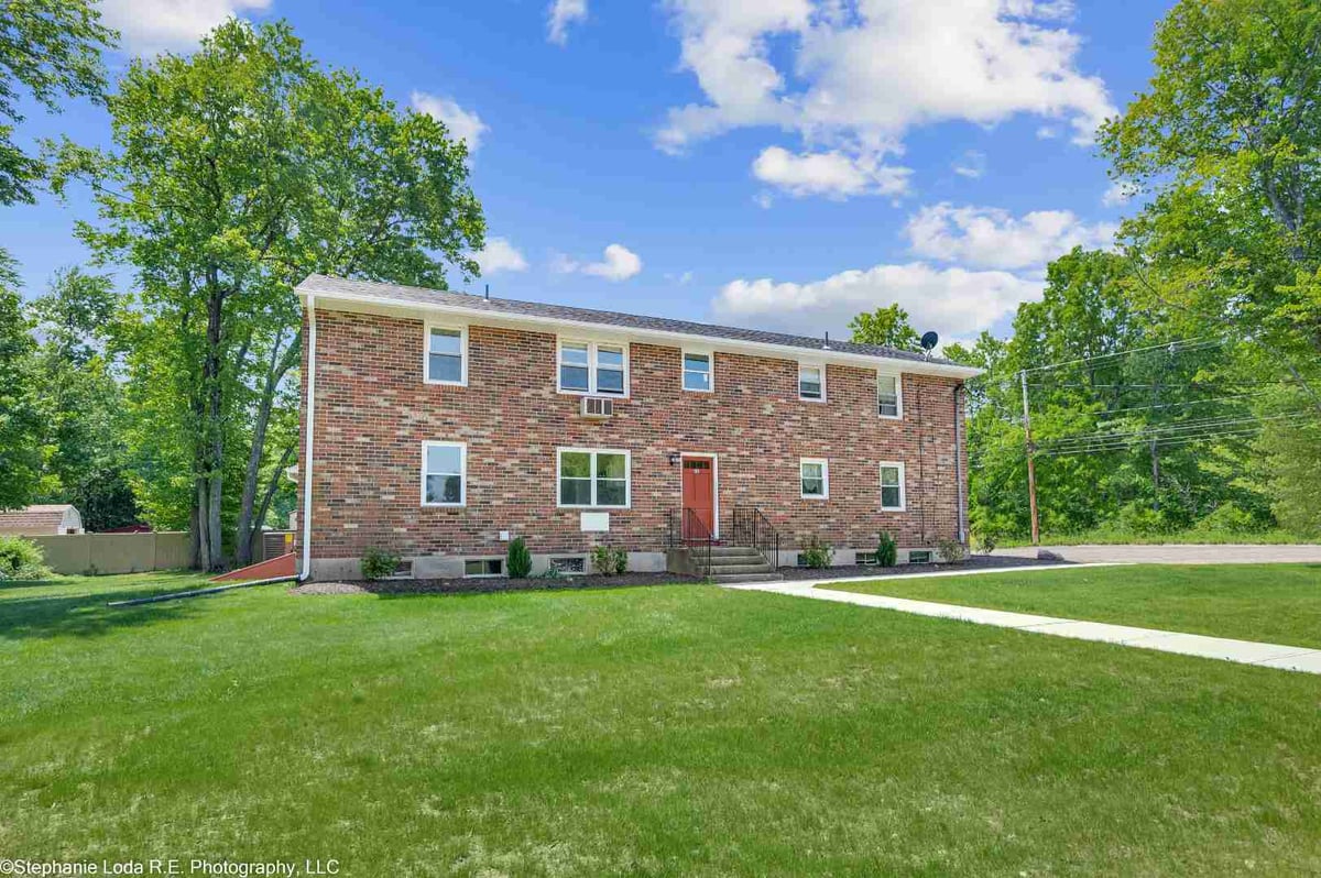 Two-story brick building with red door | rental property in Connecticut | Sunwood