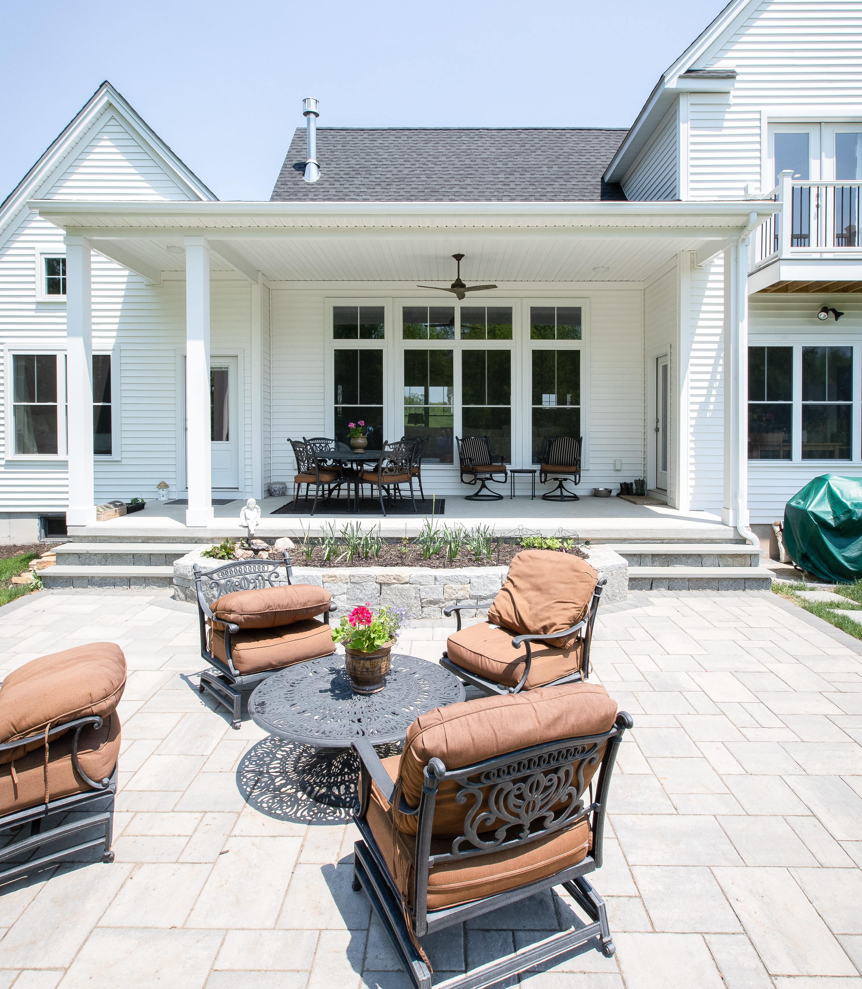 Stone Patio and Beautiful View of the Back Exterior of the Home  | Sunwood Home Builders & Remodelers