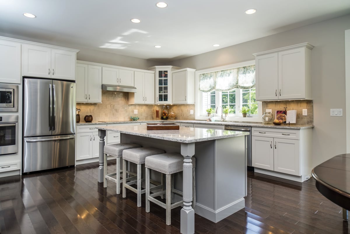Large Kitchen Island with Detailed Sides and Stainless Steal Appliances  | Sunwood Home Builders & Remodelers