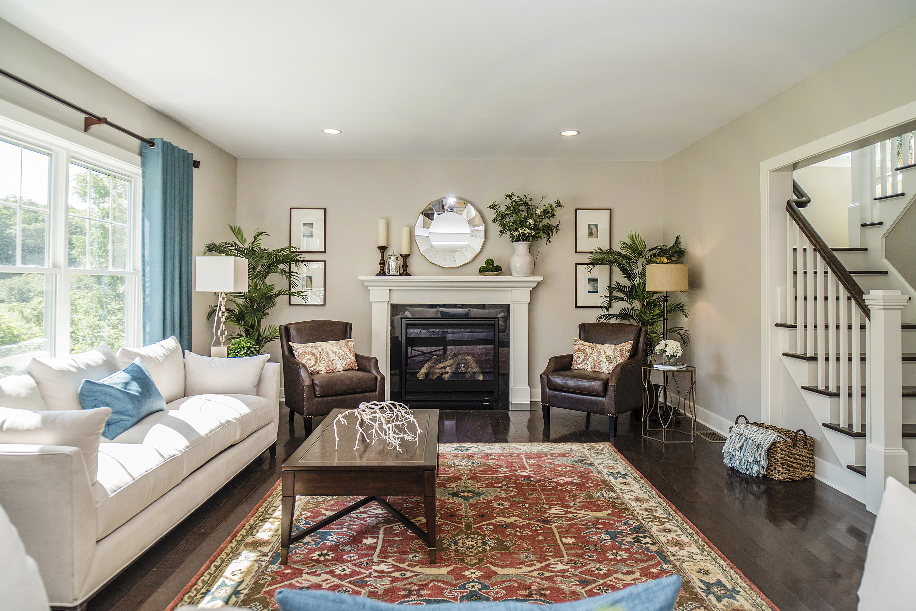 Opening Living Room with Open Front Windows and a Large Fireplace  | Sunwood Home Builders & Remodelers