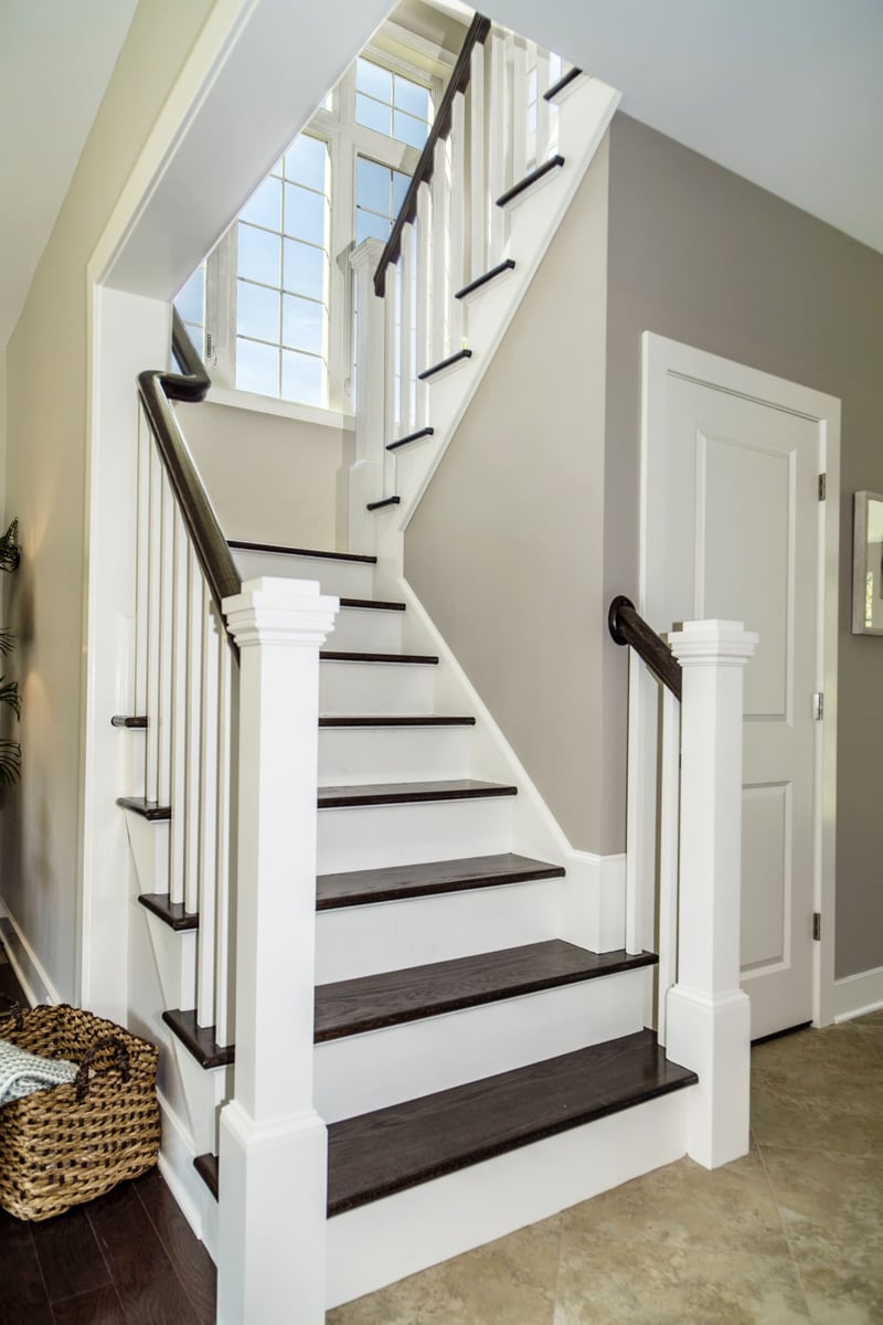 White Banister and Dark Floor Staircase  | Sunwood Home Builders & Remodelers