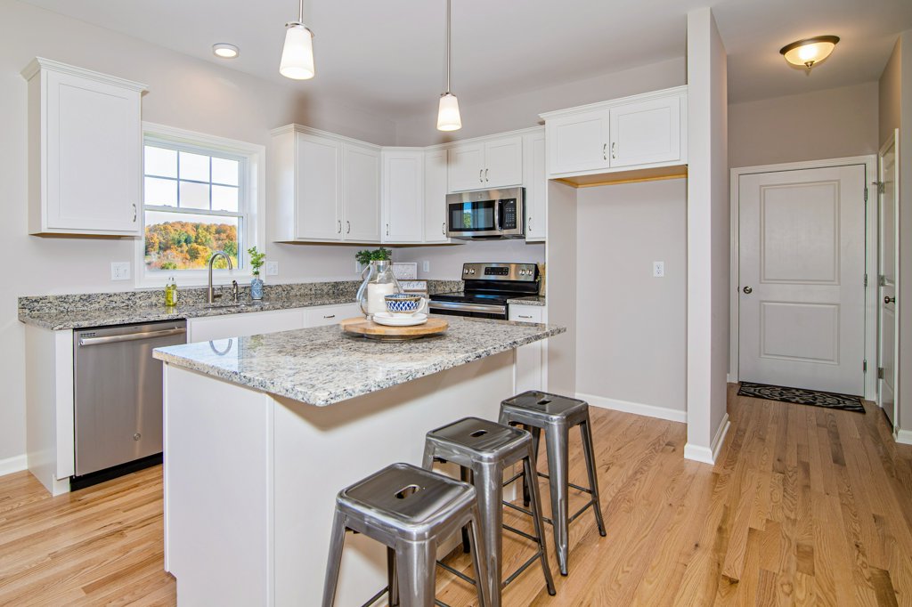 White Kitchen Cabinetry and Granite Countertops  | Sunwood Home Builders & Remodelers